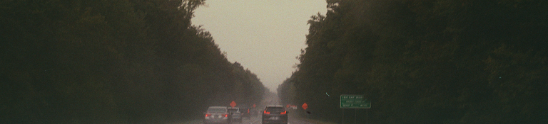 cars on the road in the rain, from the drivers seat